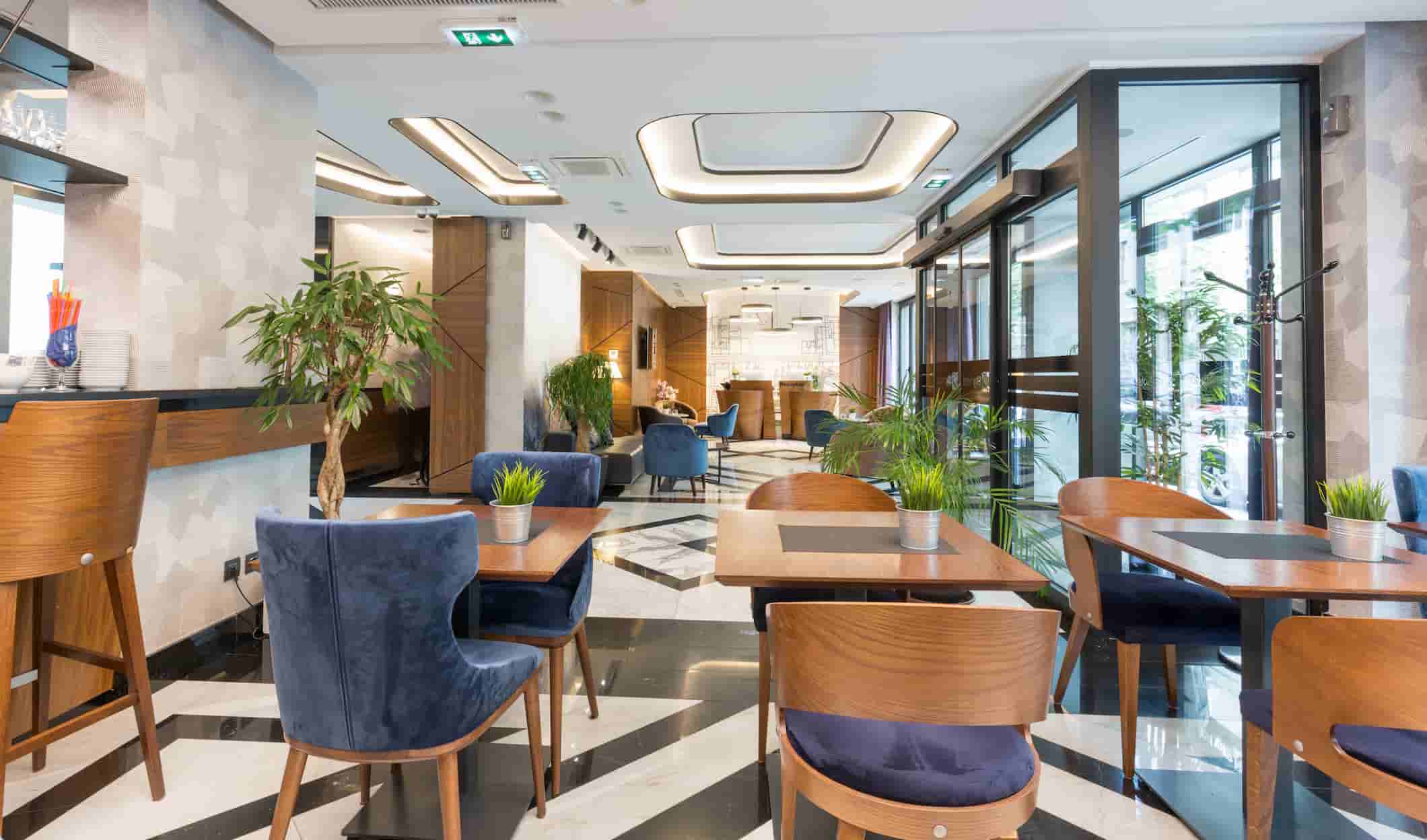 Hotel restaurant and café furniture with wooden tables and upholstered chairs for modern hospitality interiors