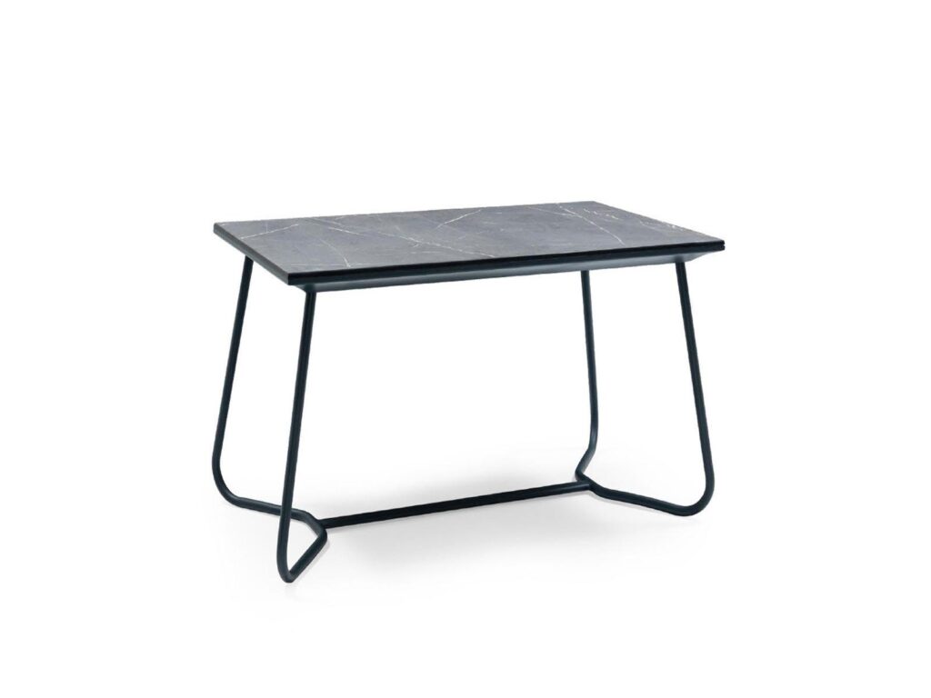 Minimalist coffee table with dark stone top and sculptural black metal legs for hotel lounges.