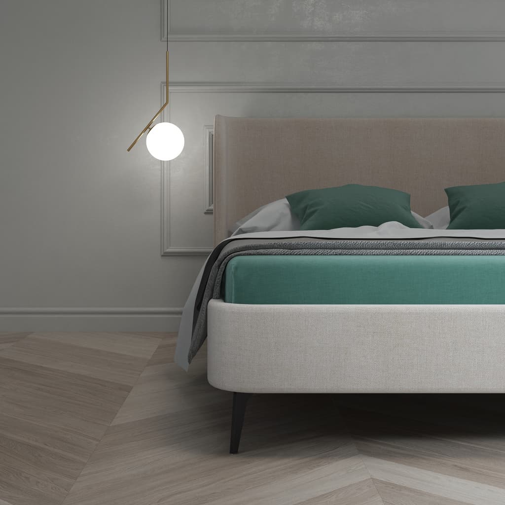 Modern upholstered hotel bed base with slim legs and integrated headboard for hospitality room projects.