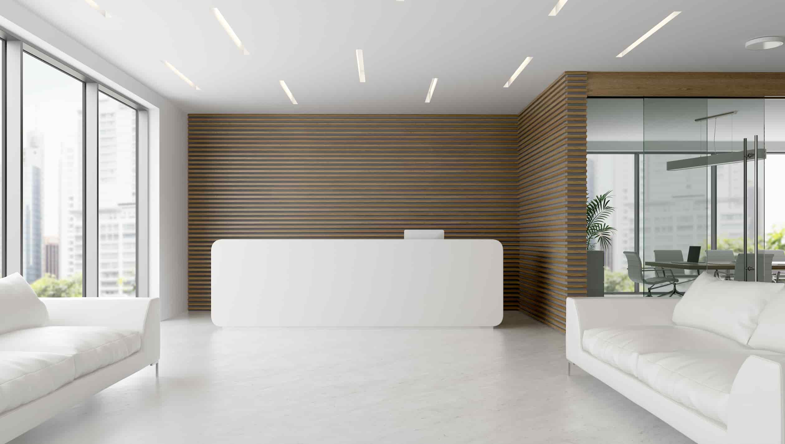 white reception desk with two sofas