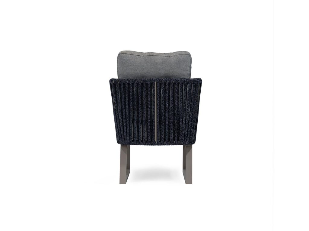 Rear view of modern lounge chair with woven backrest and upholstered cushion for hotel interiors.