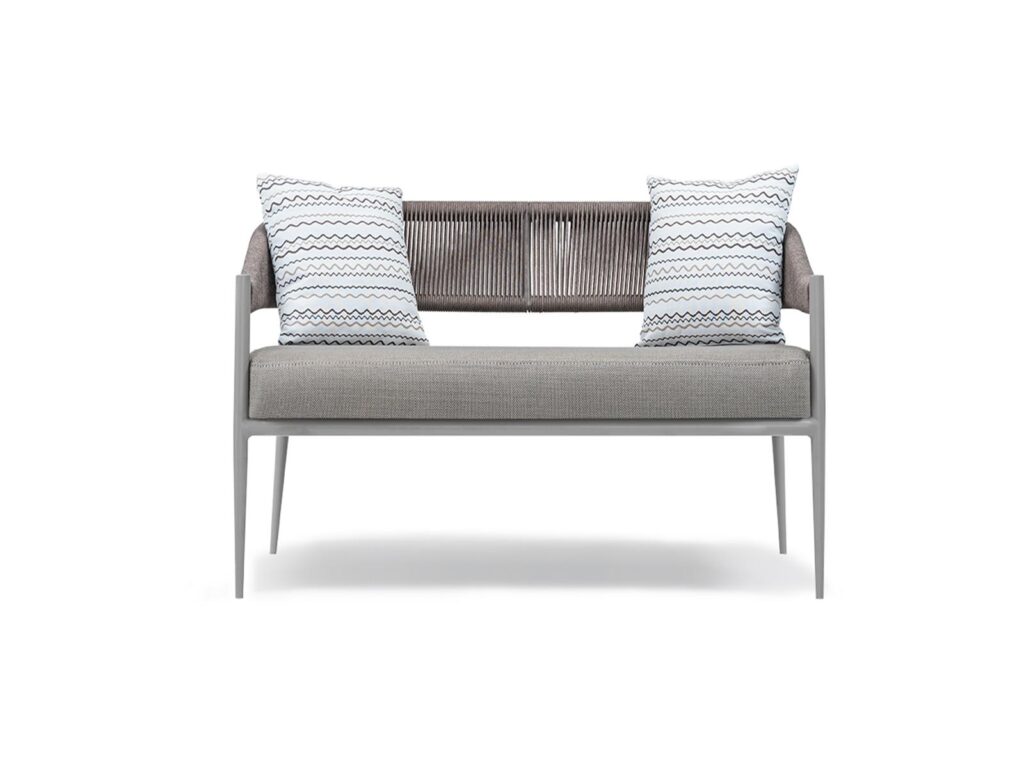 Outdoor sofa with woven backrest and cushions for hotel terrace and resort lounge areas